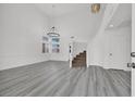 Bright living room with high ceilings, modern flooring, and staircase at 271 Francisco St, Henderson, NV 89014