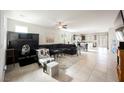 Spacious living room featuring a large sectional sofa, workspace, and tile flooring at 2721 Benton Cove St, Laughlin, NV 89029