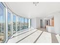 Bright living room featuring floor-to-ceiling windows with city views and tile flooring at 322 Karen Ave # 808, Las Vegas, NV 89109