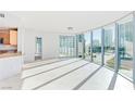 Bright living room featuring floor-to-ceiling windows with city views and tile flooring at 322 Karen Ave # 808, Las Vegas, NV 89109