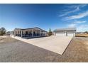 Well-maintained single-story home featuring an oversized garage and a concrete driveway at 3420 Malibou Ave, Pahrump, NV 89048