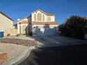 Charming two-story home featuring a terracotta roof, arched windows, and a two-car garage at 3550 Leor Ct, Las Vegas, NV 89121