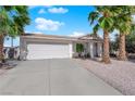 Charming home featuring desert landscaping, palm trees, a covered front entrance and a two-car garage at 3936 Savoy Ct, Las Vegas, NV 89115