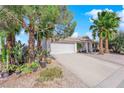 Charming home featuring desert landscaping, palm trees, a covered front entrance and a two car garage at 3936 Savoy Ct, Las Vegas, NV 89115