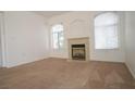 Inviting living room features a fireplace and two arch-topped windows, providing ample natural light at 4555 E Sahara Ave # 231, Las Vegas, NV 89104