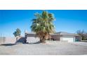 Inviting home exterior featuring desert landscaping, a spacious driveway, and a two-car garage at 4746 Rosalie Cir, North Las Vegas, NV 89031