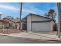 Charming single-story home featuring desert landscaping, an attached garage and a serene street view at 4775 Monaco Rd, Las Vegas, NV 89121