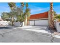 Charming two-story home featuring a two-car garage, red-tiled roof, and desert landscaping at 5102 Tennis Ct, Las Vegas, NV 89120