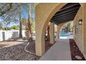 Covered patio with arched openings leading to a sparkling pool at 5102 Tennis Ct, Las Vegas, NV 89120