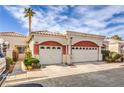 A charming home with a terracotta-tiled roof and manicured landscaping, complemented by desert accents and an attached garage at 5185 Briar Meadow Way, Las Vegas, NV 89118