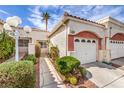 A charming stucco house featuring a beautiful entry gate, terracotta roof, desert landscaping and an attached garage at 5185 Briar Meadow Way, Las Vegas, NV 89118