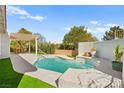 Backyard with a refreshing swimming pool, a patio area, and lush landscaping at 5520 Cranwood Ct, Las Vegas, NV 89130