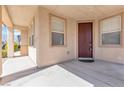 View of the front porch with a welcoming entryway and a large window at 5616 Dunshee Vista Ave, Las Vegas, NV 89131