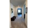 Bright hallway featuring neutral paint, carpet and access to the living area at 5980 E Drosetta Ave, Pahrump, NV 89061