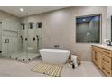 Serene bathroom with a freestanding tub, glass shower, natural light and sleek modern finishes at 6009 Silvalde Ln, Las Vegas, NV 89135