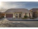 Charming single-story home with a well-maintained lawn, neutral stucco, stone accents, and a brown tile roof at 6021 Vista Clara St, Las Vegas, NV 89148