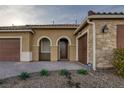 Inviting home exterior with stone accents, desert landscaping, and covered front porch entry at 6021 Vista Clara St, Las Vegas, NV 89148