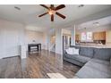 Open floor plan living room with dark wood floors, neutral walls, and natural light at 608 Breezy Sage Ct, Henderson, NV 89015