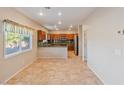 Open concept kitchen area with modern appliances, tile flooring, and natural light at 6337 Black Mane Way, North Las Vegas, NV 89081