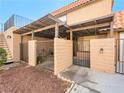 This cozy patio area has brick fencing and a shade cover, ideal for outdoor seating and relaxation at 6630 Bubbling Brook Dr # C, Las Vegas, NV 89107