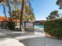 The secure gated pool area offers a refreshing escape with mature trees providing shade and privacy at 6630 Bubbling Brook Dr # C, Las Vegas, NV 89107