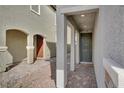 Inviting covered entryway with tiled pathway, pillars, and a modern front door with decorative hardware at 6988 Sylmar Ave, Las Vegas, NV 89113