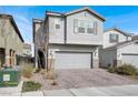 Two-story home showcasing a two-car garage, neutral stucco, and a paved driveway with desert landscaping at 6988 Sylmar Ave, Las Vegas, NV 89113