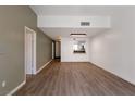 Open-concept living room with wood floors leading into a view of the kitchen at 7100 Pirates Cove Rd # 2067, Las Vegas, NV 89145