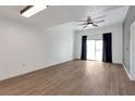 Bright living room featuring a ceiling fan, wood floors, and natural light at 7100 Pirates Cove Rd # 2067, Las Vegas, NV 89145