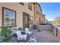 Cozy patio with seating, lush landscaping, and a charming outdoor space at 720 Sleeping City Ave, Henderson, NV 89015