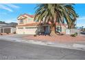 This lovely two-story home boasts a three-car garage and mature landscaping, including a large palm tree at 7400 Wheat Grass Ct, Las Vegas, NV 89129