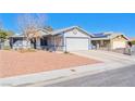 Single story house shows a charming residence with a spacious driveway and desert landscaping at 7436 Lattimore Dr, Las Vegas, NV 89128