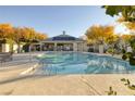 Sparkling community pool with inviting lounge area and shaded seating, perfect for relaxation at 8234 Misty Sage St, Las Vegas, NV 89139