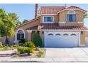 Charming two-story home with a well-maintained lawn and garden, showcasing its appealing curb appeal at 8262 Huxley St, Las Vegas, NV 89123