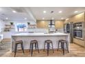 Bright, open kitchen featuring a large island with seating, modern appliances, and sleek cabinetry at 8645 Edmond St, Las Vegas, NV 89139