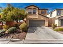 Charming two-story home with two car garage, desert landscaping and a concrete driveway at 8699 Grand Sequoia St, Las Vegas, NV 89139