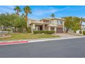 Beautiful home showcasing a well-kept lawn, mature trees, and a two-car garage at 8800 Las Olivas Ave, Las Vegas, NV 89147