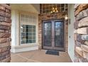 Elegant front entrance featuring double doors, stone accents, and a welcoming covered porch at 8800 Las Olivas Ave, Las Vegas, NV 89147