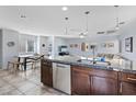 Kitchen featuring dark cabinetry, granite countertops, stainless steel appliances, and an open floor plan at 10525 Gibbous Moon Dr, Las Vegas, NV 89129