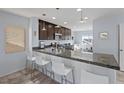 Bright kitchen featuring an eat-in breakfast bar, stainless steel appliances, and a large window at 10525 Gibbous Moon Dr, Las Vegas, NV 89129