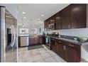 Open kitchen featuring stainless steel appliances, dark cabinetry, and great natural lighting at 10525 Gibbous Moon Dr, Las Vegas, NV 89129