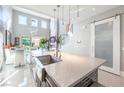 Bright kitchen island with quartz countertop, stainless steel sink, and open layout to living area at 10605 Harvest Green Way, Las Vegas, NV 89135