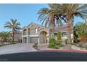 Beautiful two-story home featuring a tile roof, palm trees, and arched entry at 11158 Antonine Wall Ct, Las Vegas, NV 89141