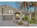 Attractive two-story home with palm trees, a tile roof and brick driveway at 11158 Antonine Wall Ct, Las Vegas, NV 89141