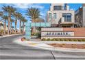 Community entrance with desert landscaping and modern signage under blue skies at 11230 Hidden Peak Ave # 207, Las Vegas, NV 89135