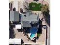 Aerial view of a property showing the house, roof, pool, yard, and driveway at 200 E Desert Rose Dr, Henderson, NV 89015