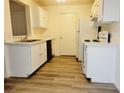 Functional kitchen with white appliances and plenty of cabinet space for storage at 221 Mission Newport Ln # 208, Las Vegas, NV 89107