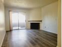 Inviting living room with modern floors, fireplace and sliding glass door to patio at 221 Mission Newport Ln # 208, Las Vegas, NV 89107