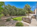 The backyard provides a serene retreat with a seating area, lush greenery, and a well-maintained lawn at 23 Antero Dr, Henderson, NV 89074