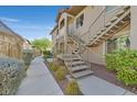 Exterior of building featuring stairs to upper units and a sidewalk bordered by green bushes at 2305 W Horizon Ridge Pkwy # 3324, Henderson, NV 89052